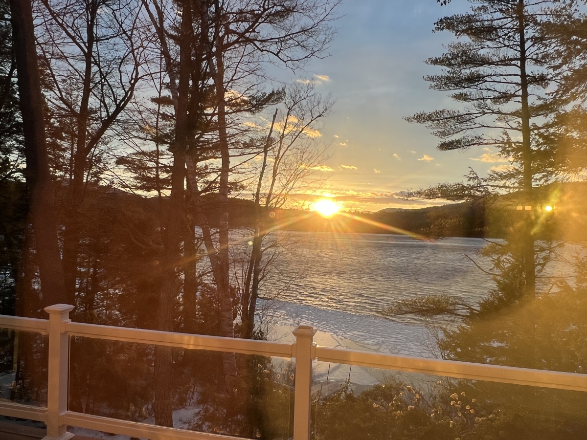 View of the sunset over the lake and mountains from the deck